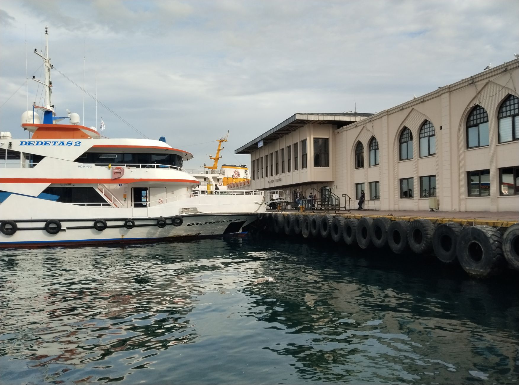 Santorini ferry port with boats and passengers