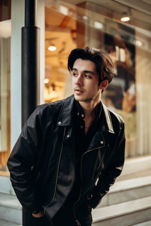 Free Portrait of a young man in leather jacket, urban background, trendy style. Stock Photo