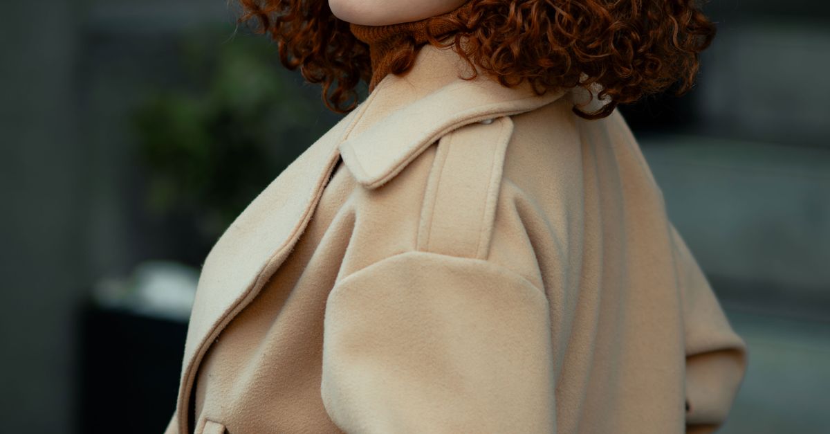 Woman in a camel wool coat over a tailored suit