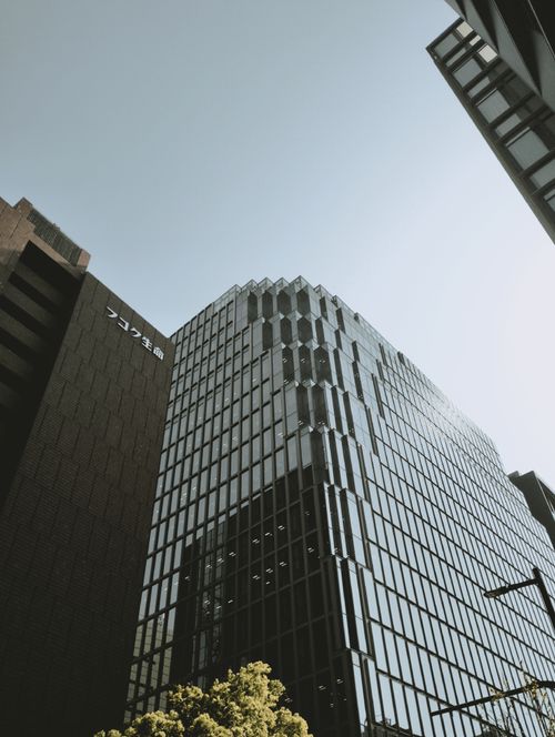 Free Vertical shot of contemporary glass skyscrapers in Fukuoka under clear sky. Stock Photo