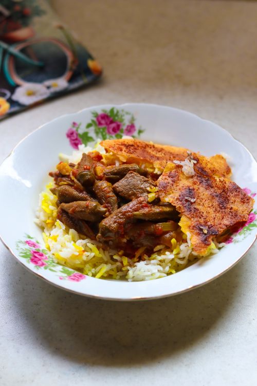 Delicious Persian Rice and Beef Dish in Floral Bowl · Free Stock Photo