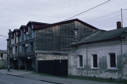 Free Aged urban buildings with weathered appearances under an overcast sky, capturing an industrial atmosphere. Stock Photo