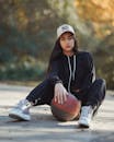Young Woman in Casual Sportswear with Basketball