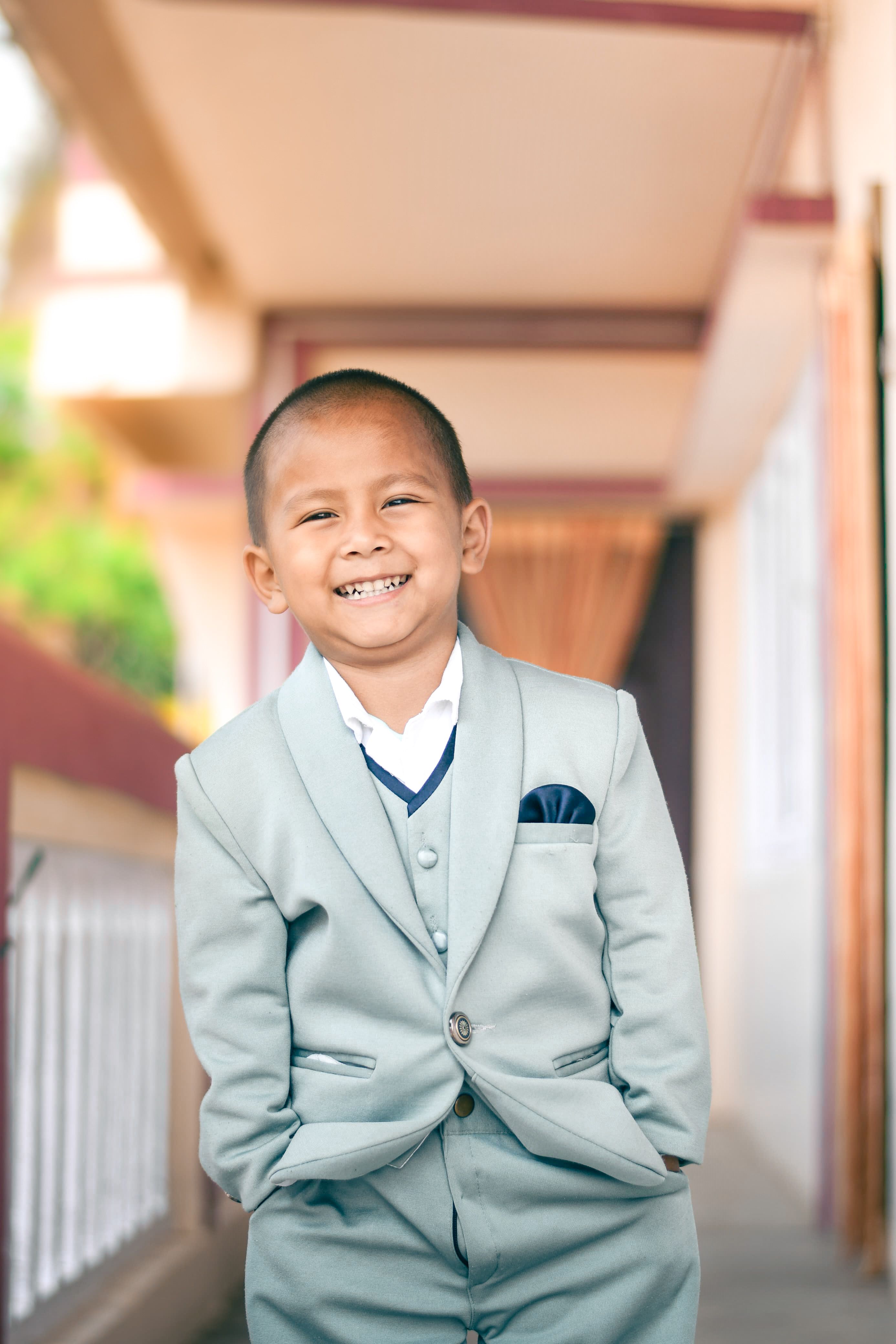 Charming Boy in Formal Suit Smiling Outdoors  Free Stock Photo