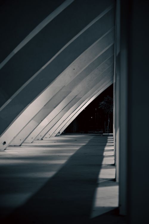 Free Monochrome view of concrete arches with dramatic light and shadow play. Stock Photo