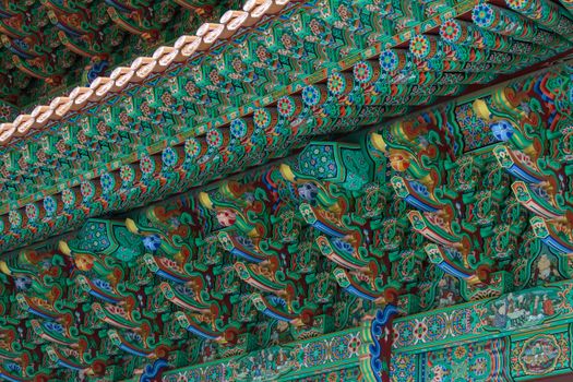 Vibrant and intricate details of a traditional Korean temple ceiling showcasing rich colors and patterns.