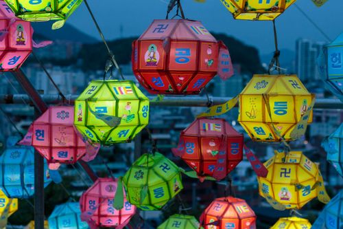 Free Vibrant paper lanterns hanging outdoors at night, capturing cultural festivity and city background. Stock Photo