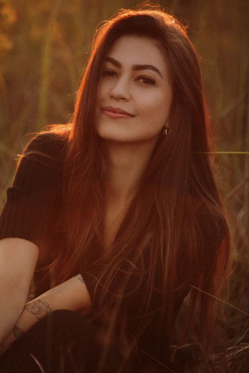 Free A serene outdoor portrait capturing a woman during golden hour, South Brazil. Stock Photo