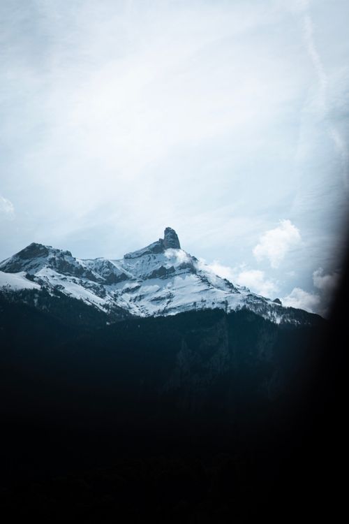 Free Breathtaking view of a snow-capped mountain peak in the Swiss Alps on a clear day. Stock Photo