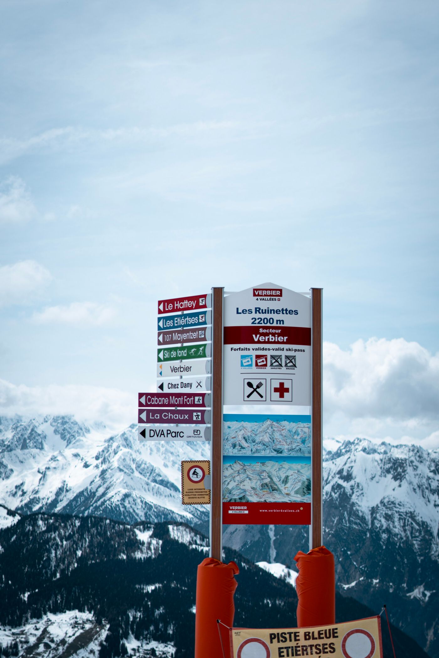Winter view at Les Ruinettes, part of the Verbier ski area in Switzerland, with snow-covered mountains and ski signage.