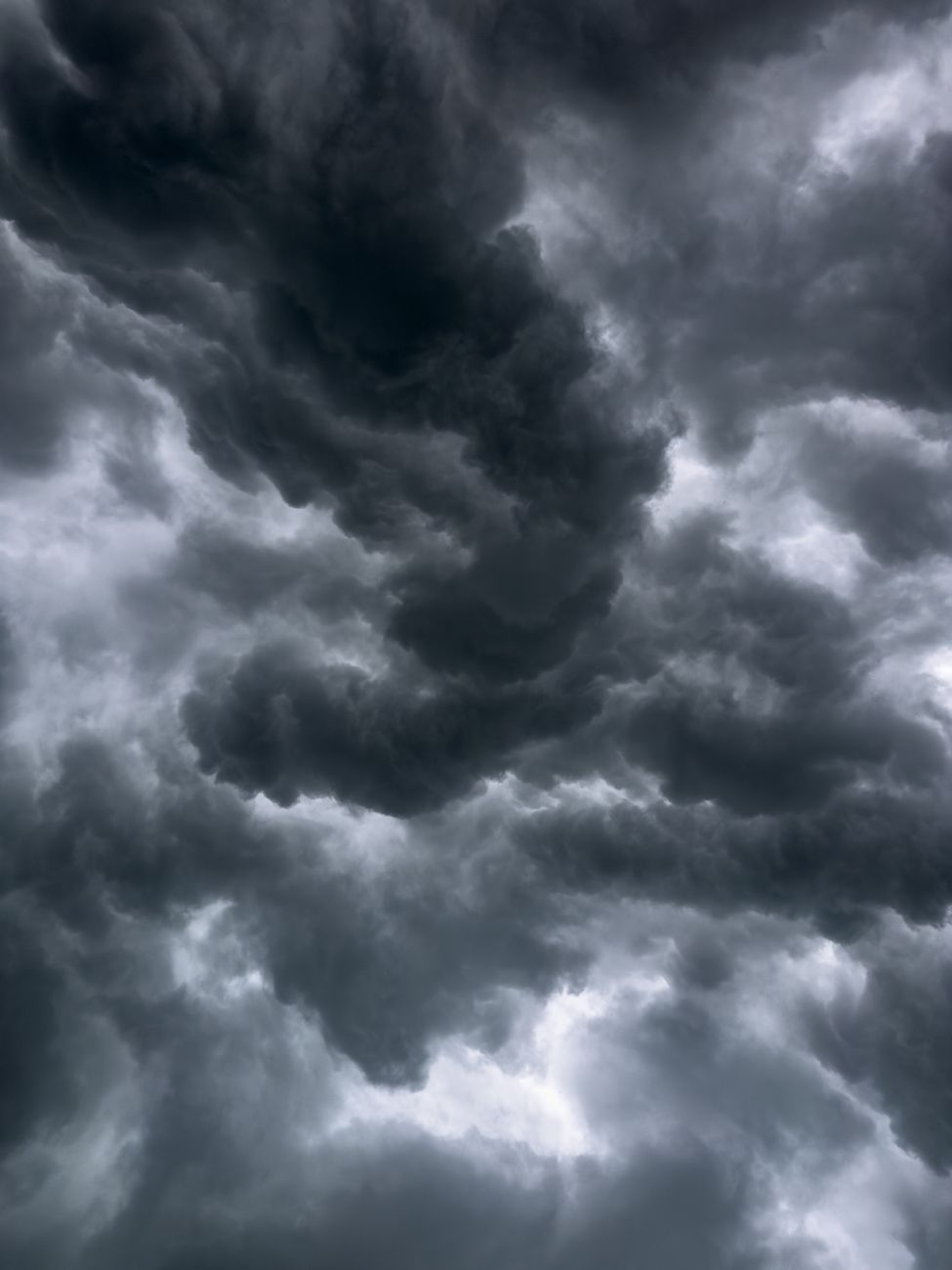 A moody sky filled with dramatic storm clouds, showcasing nature's power.. moody, filled, with