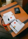 Vintage Polaroid Instant Cameras on Brown Leather Desk