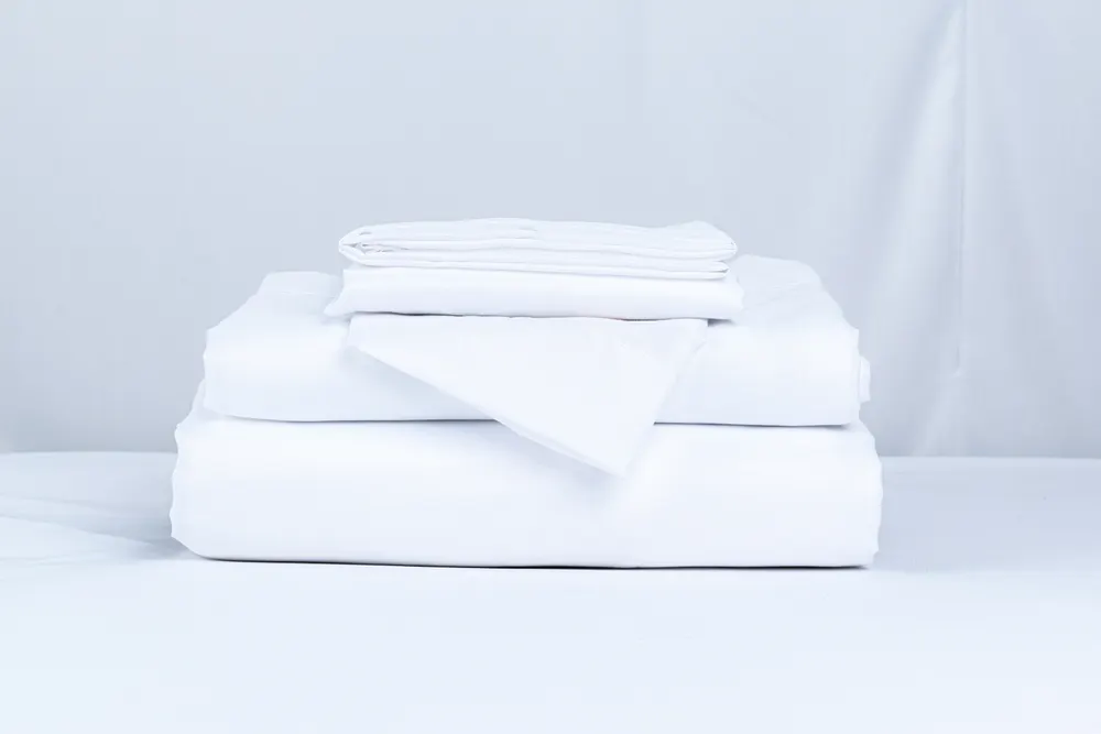 Stack of folded white bed linens