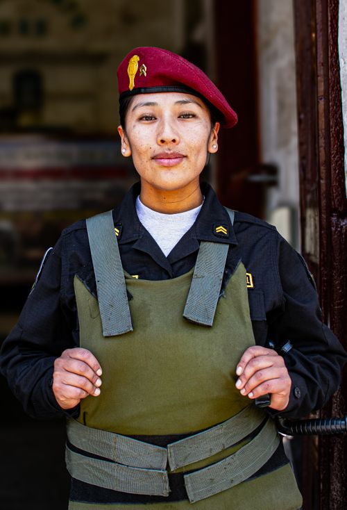 Free Confident military officer with red beret and body armor in doorway. Stock Photo