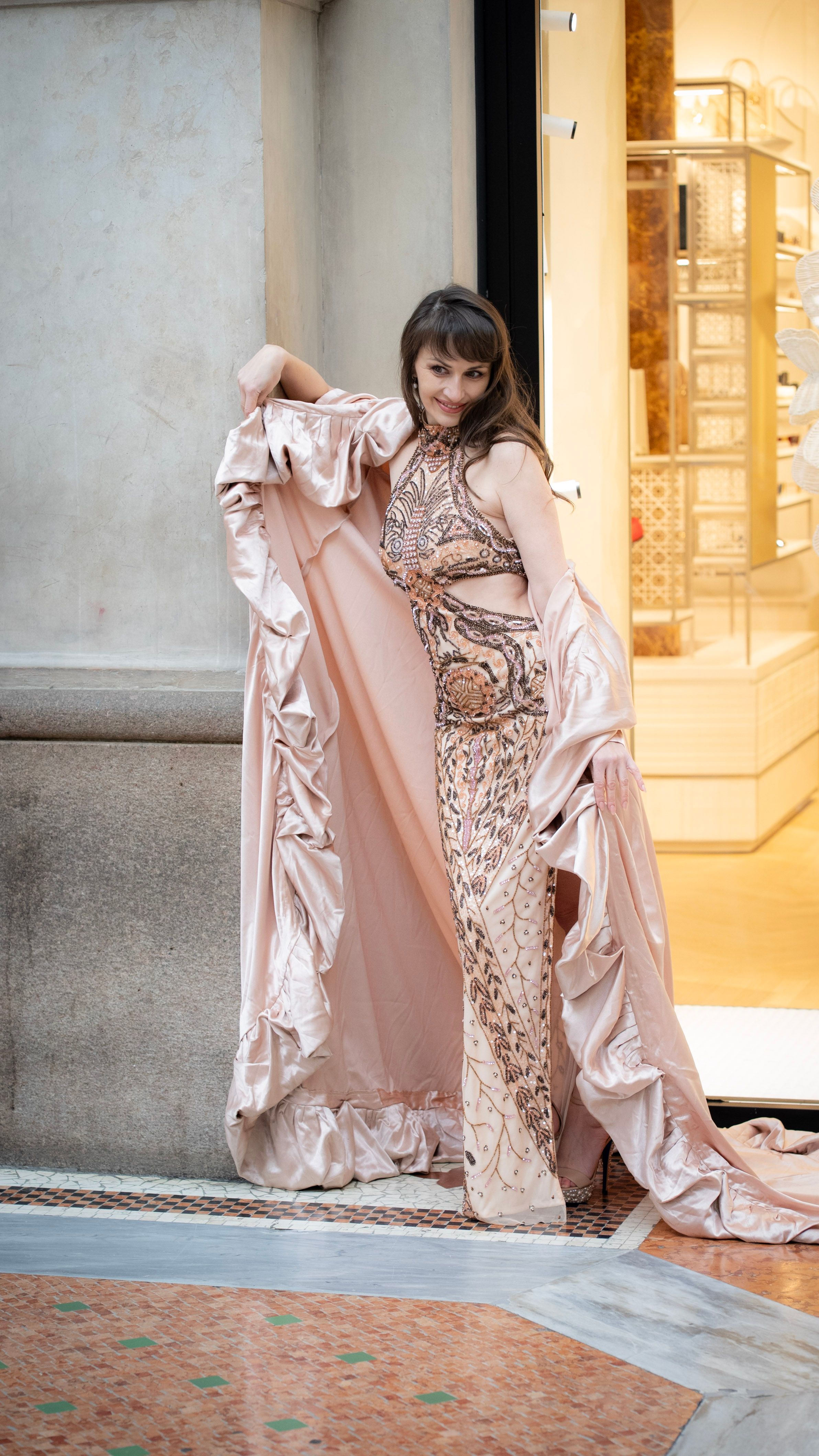 Caucasian woman in glamorous attire posing stylishly in Milan's famous fashion district.