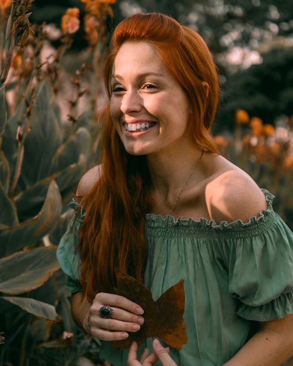 Smiling Woman Holding Leaf
