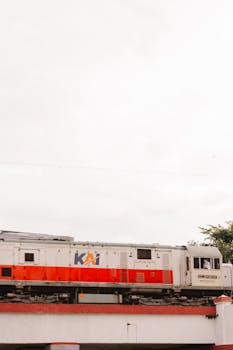 A scenic view of a train moving through Bandung, highlighting urban Indonesia.