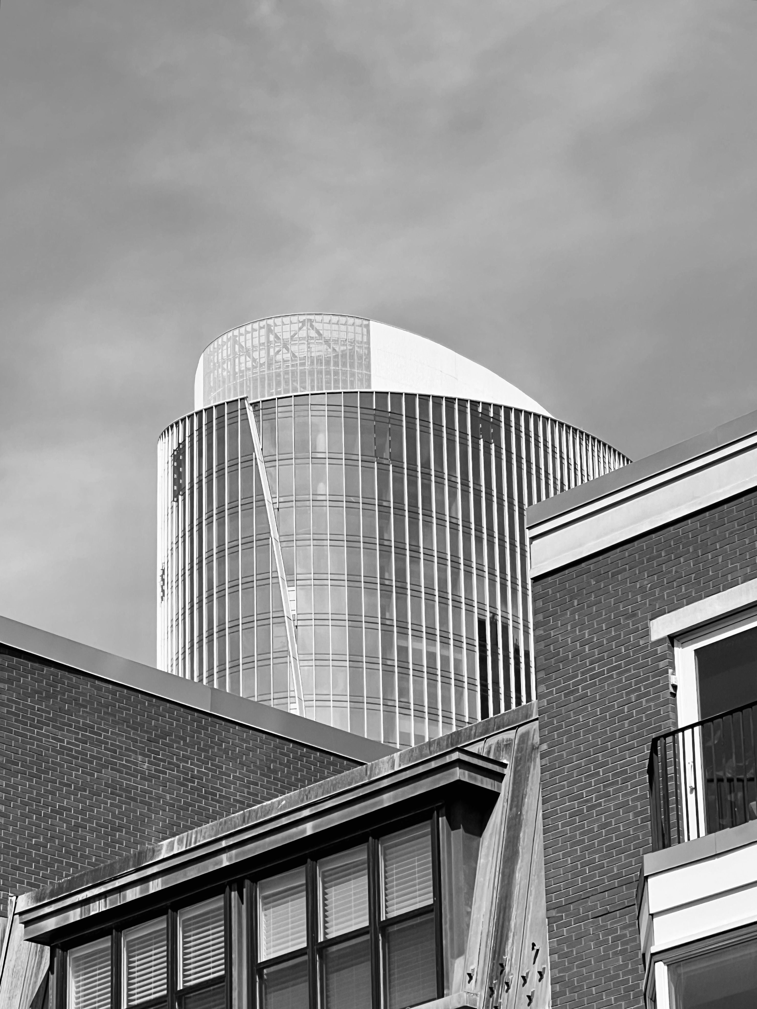 Modern skyscraper behind urban architecture · Free Stock Photo