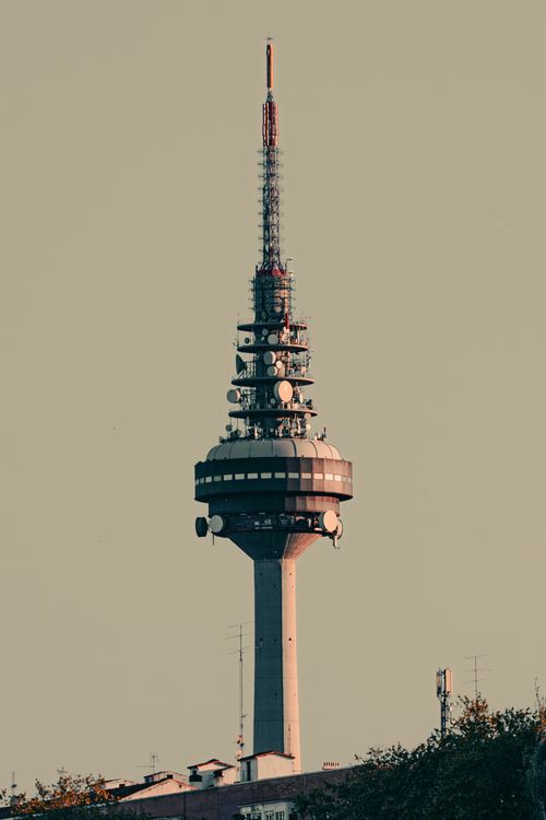 Free Torrespaña communication tower in Madrid cityscape under a clear sky. Stock Photo