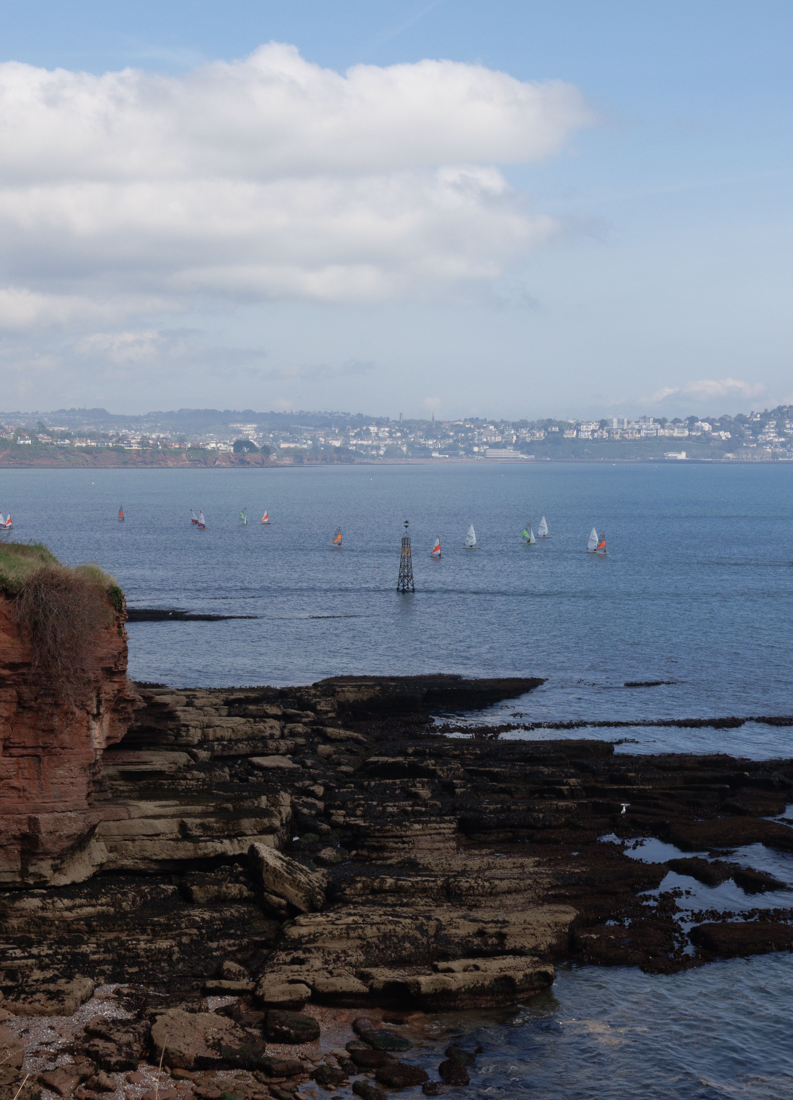 Coastal Cliffs Overlooking the Sea with Sailboats · Free Stock Photo