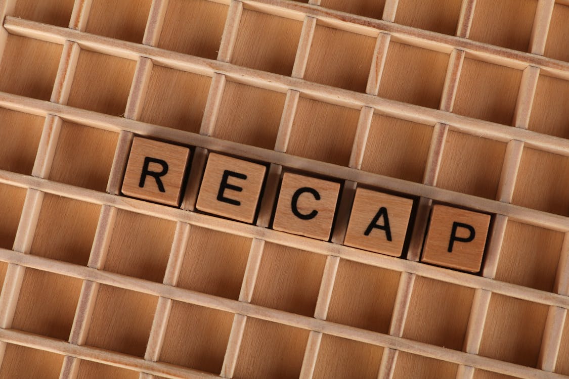 Wooden Letter Blocks Spelling 'Recap' on Grid · Free Stock Photo
