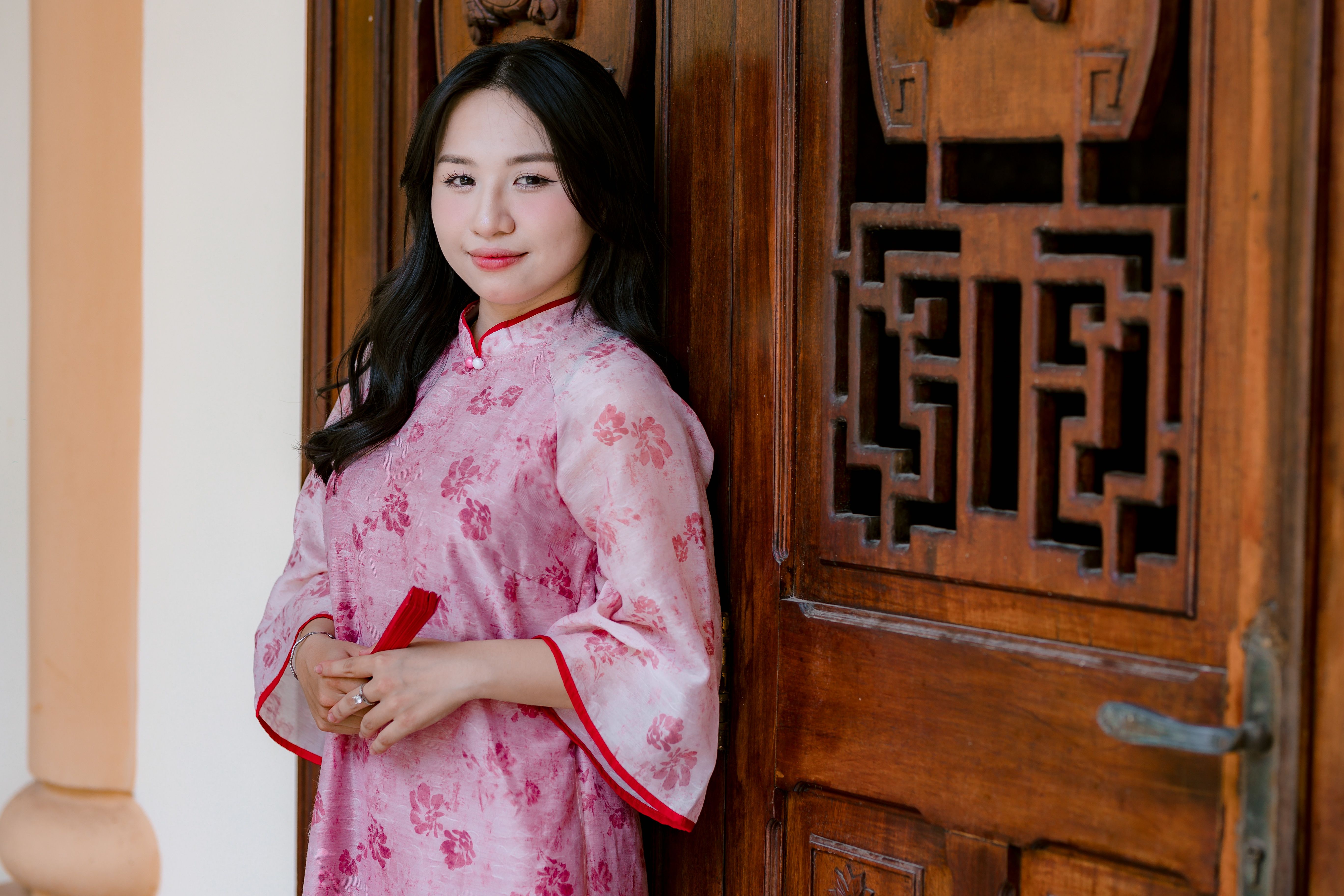 Woman in Traditional Dress by Wooden Door · Free Stock Photo
