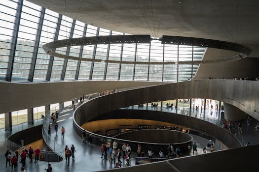Explore the spiraling architecture inside a modern museum with visitors.