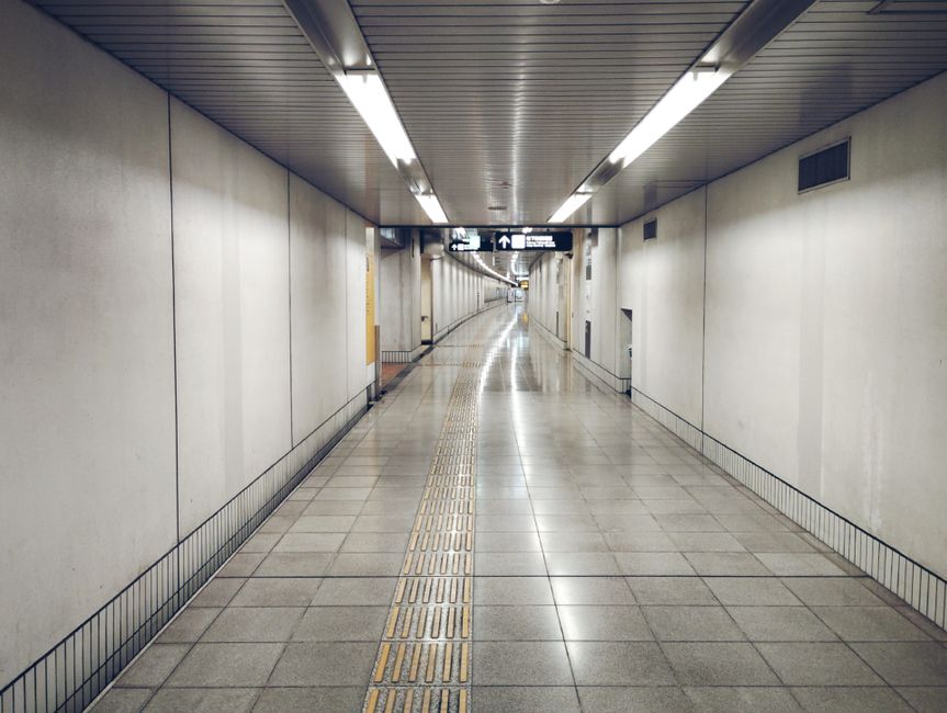 Gangnam Station underground shopping corridor with bright fluorescent lighting and pedestrians