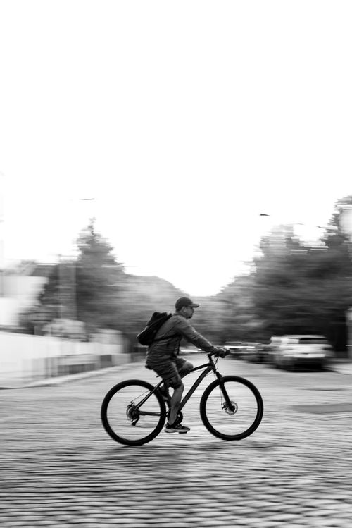Free Blurred motion capture of a cyclist in Buenos Aires, showcasing urban life in black and white. Stock Photo