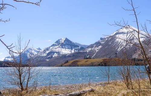 Free Breathtaking view of Waterton Lake surrounded by majestic snow-capped mountains in spring. Stock Photo