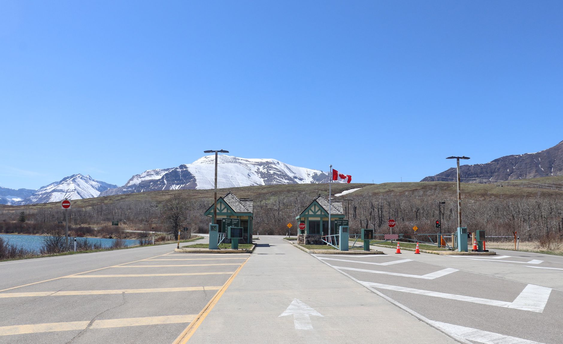 Temporary Resident Permit (TRP): How to Enter This Year 2 Canadian border crossing amidst stunning snow-capped mountains and clear blue sky.