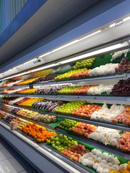 A vibrant array of fruits neatly displayed in a grocery store in Lipa, Calabarzon.