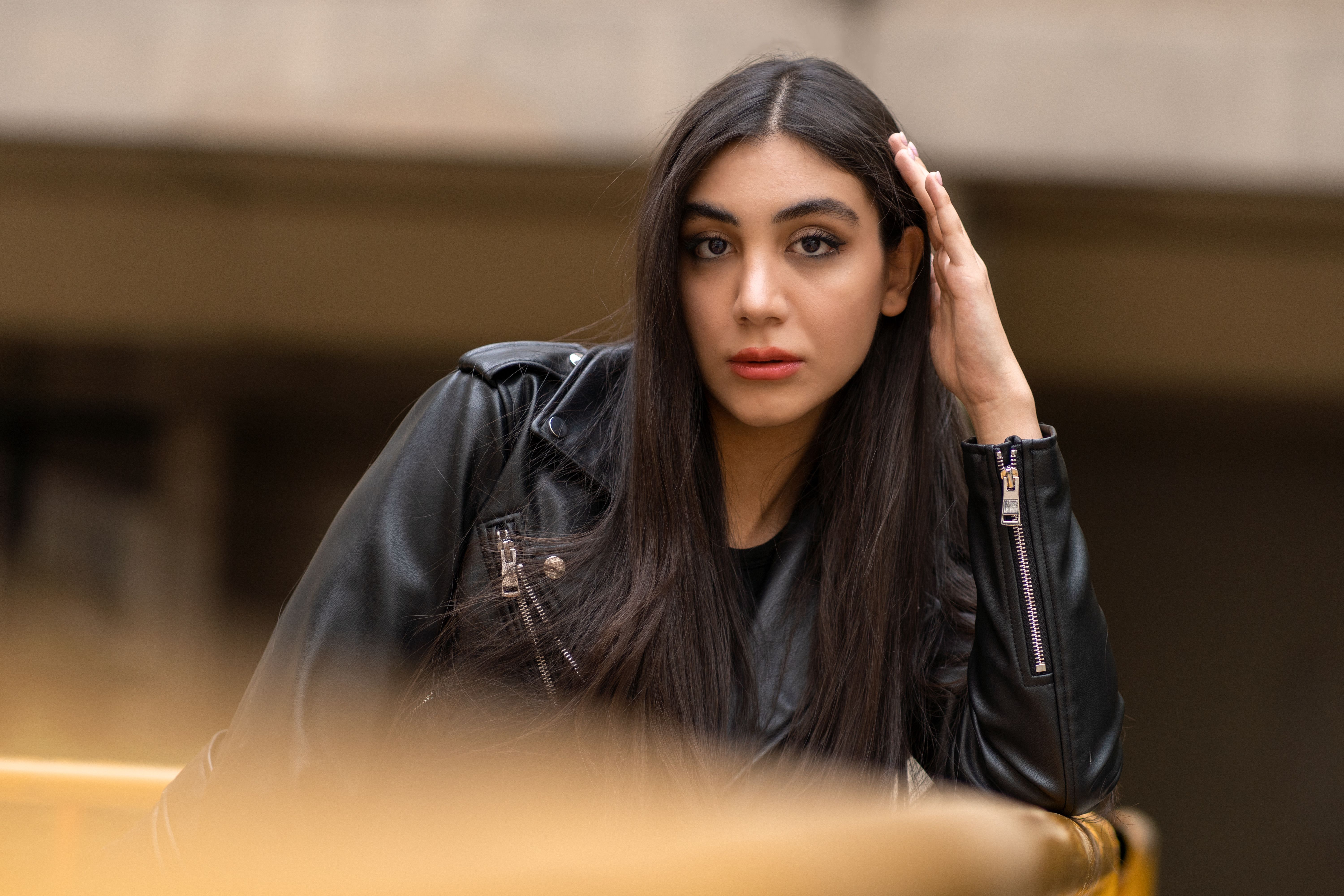 Woman in black leather jacket outdoors