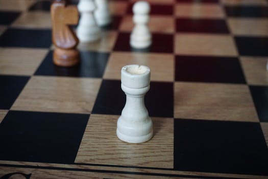 Close-up of a rook on a chessboard, highlighting strategic gameplay.