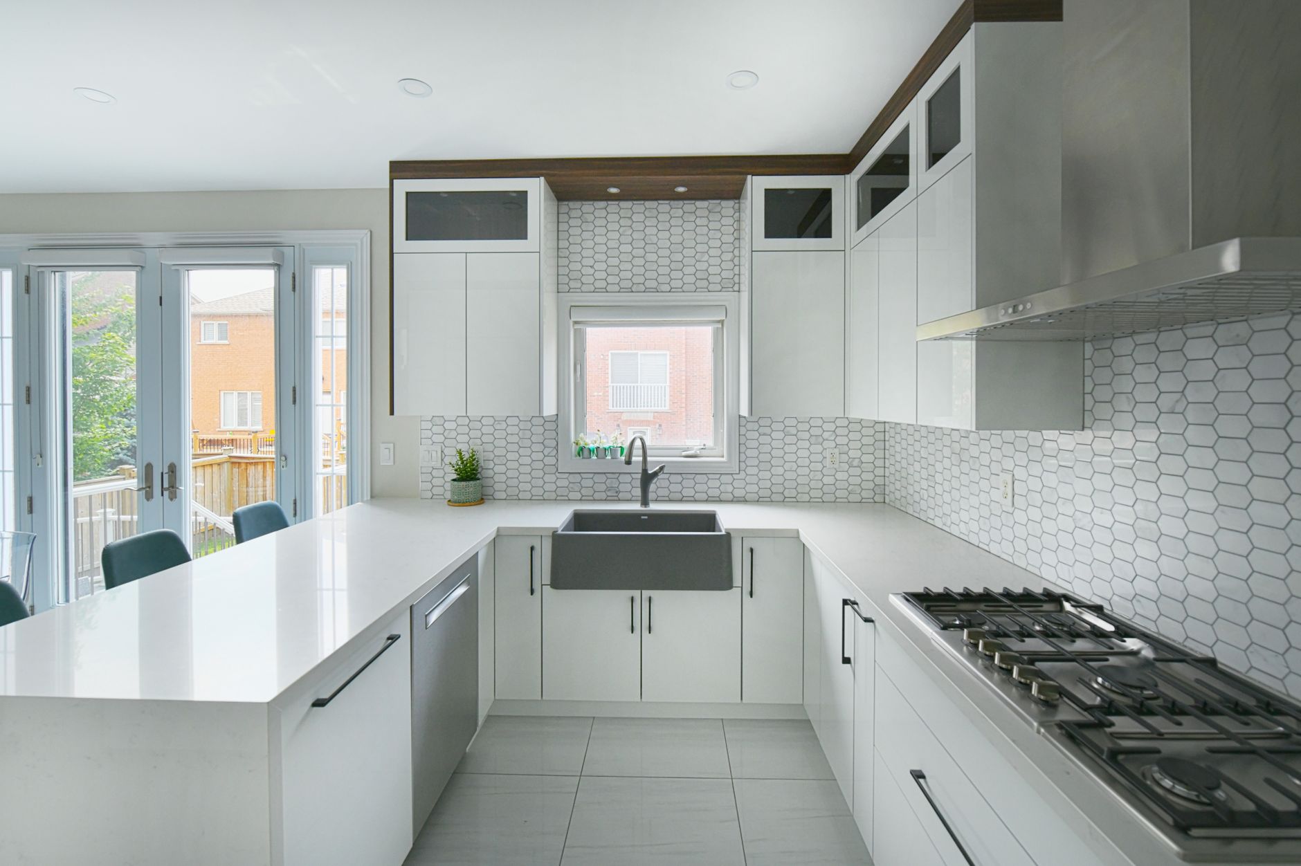 Renovated modern kitchen with white quartz countertops, updated cabinetry, and stainless appliances