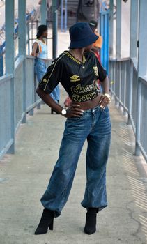 Confident person wearing trendy streetwear in an urban environment.