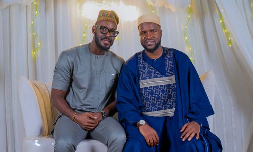 Free Two adult men in traditional African clothing seated indoors, smiling. Stock Photo