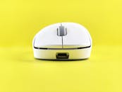 Minimalist White Mouse on Vibrant Yellow Background
