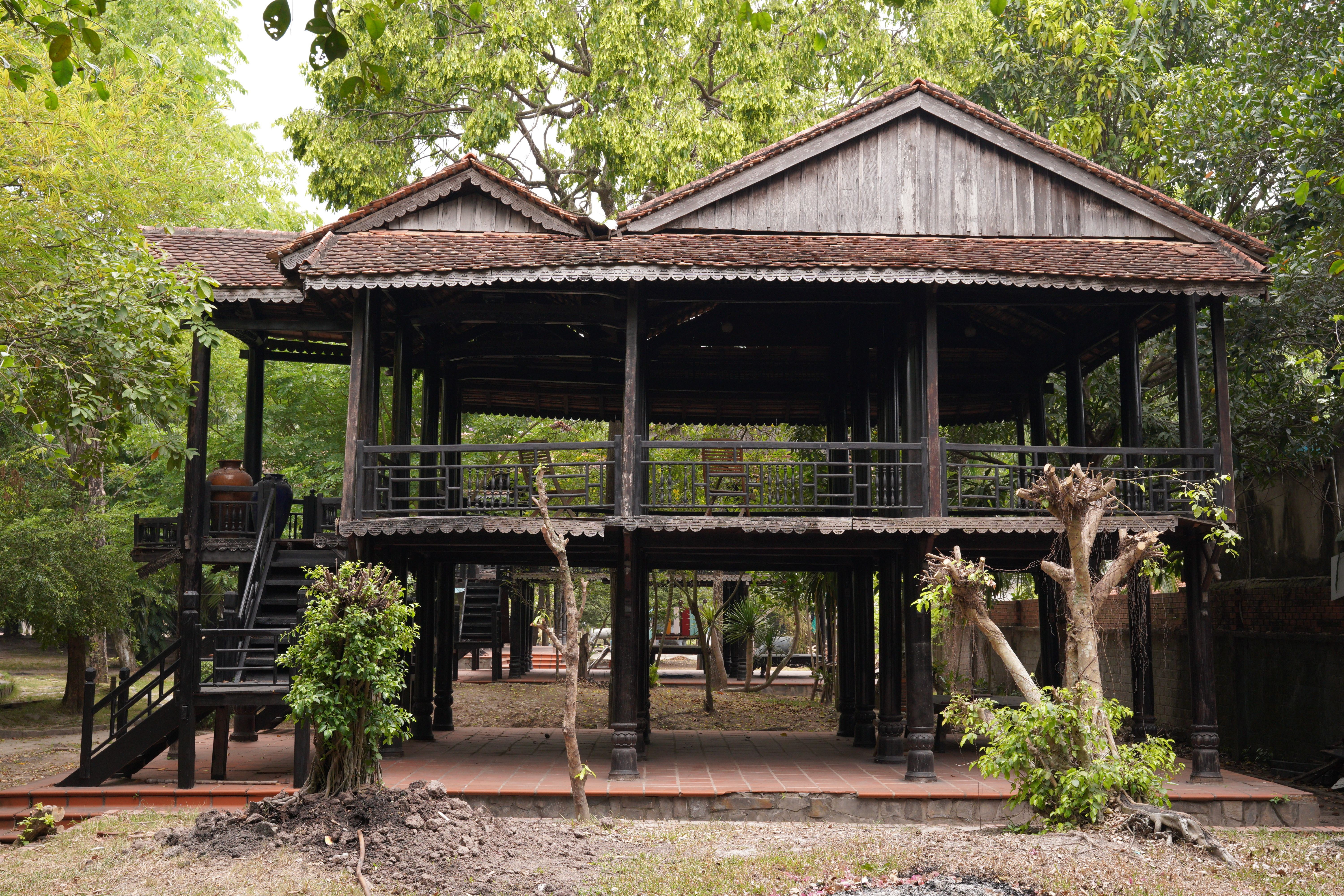 Traditional Wooden Elevated House in Lush Setting · Free Stock Photo
