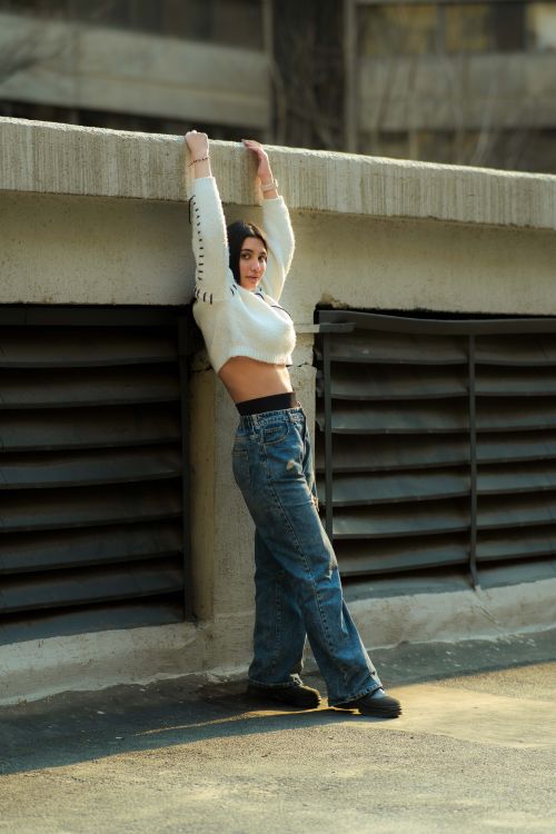 Stylish Woman Posing in Urban Street Setting · Free Stock Photo
