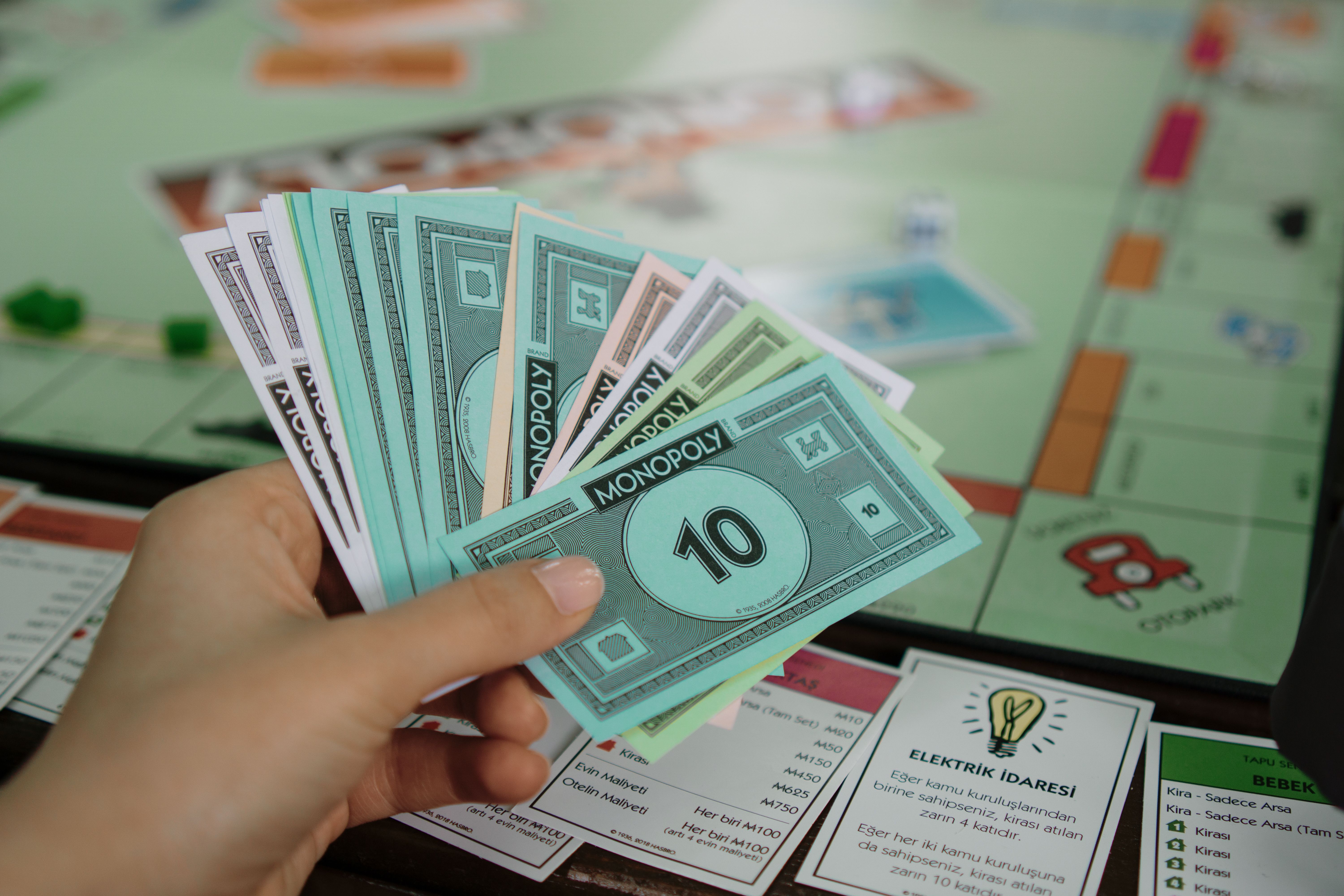 Close-up of Hand Holding Monopoly Money · Free Stock Photo
