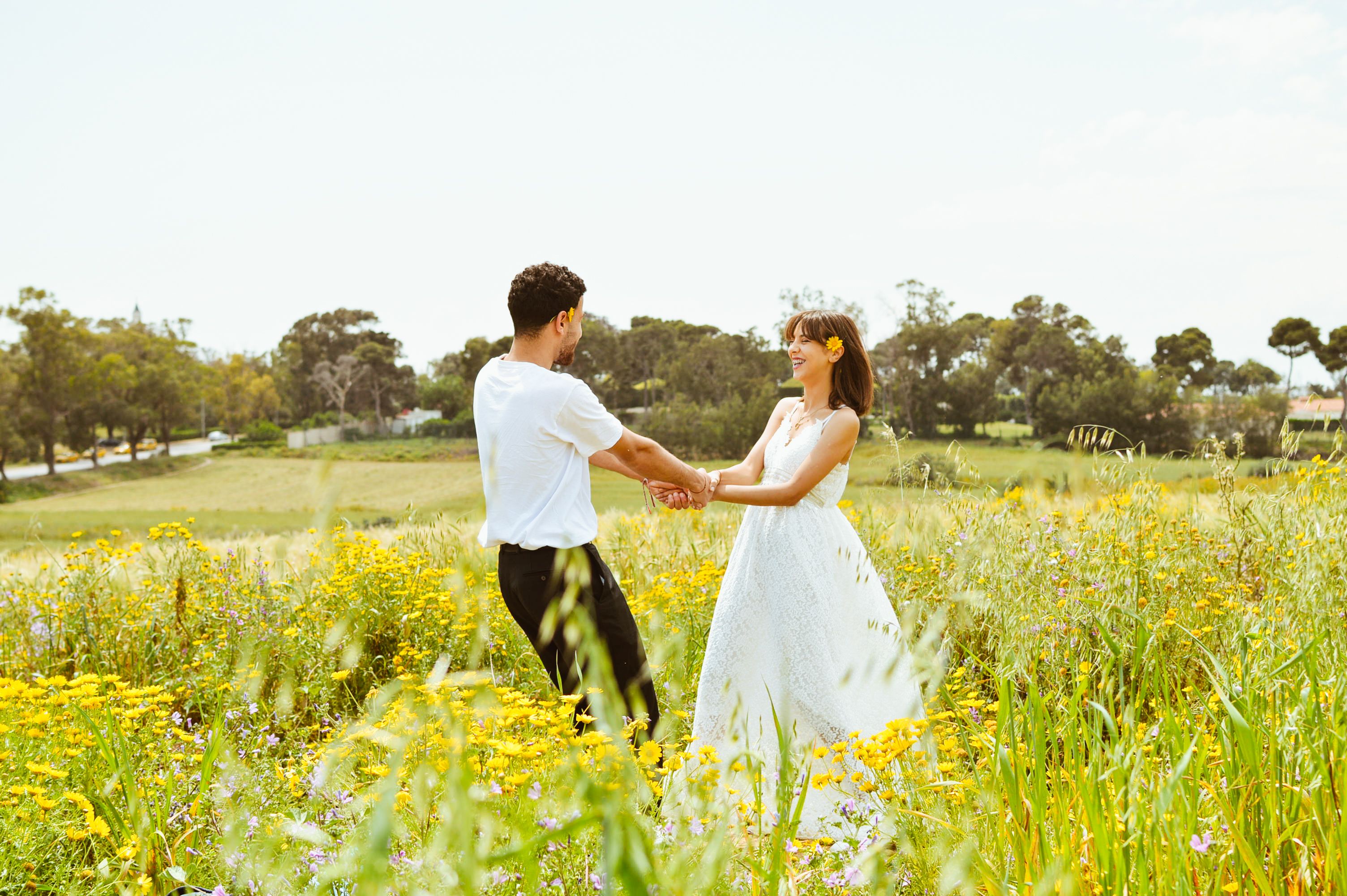 Romantic Couple Dancing in a Sunny Flower Field · Free Stock Photo