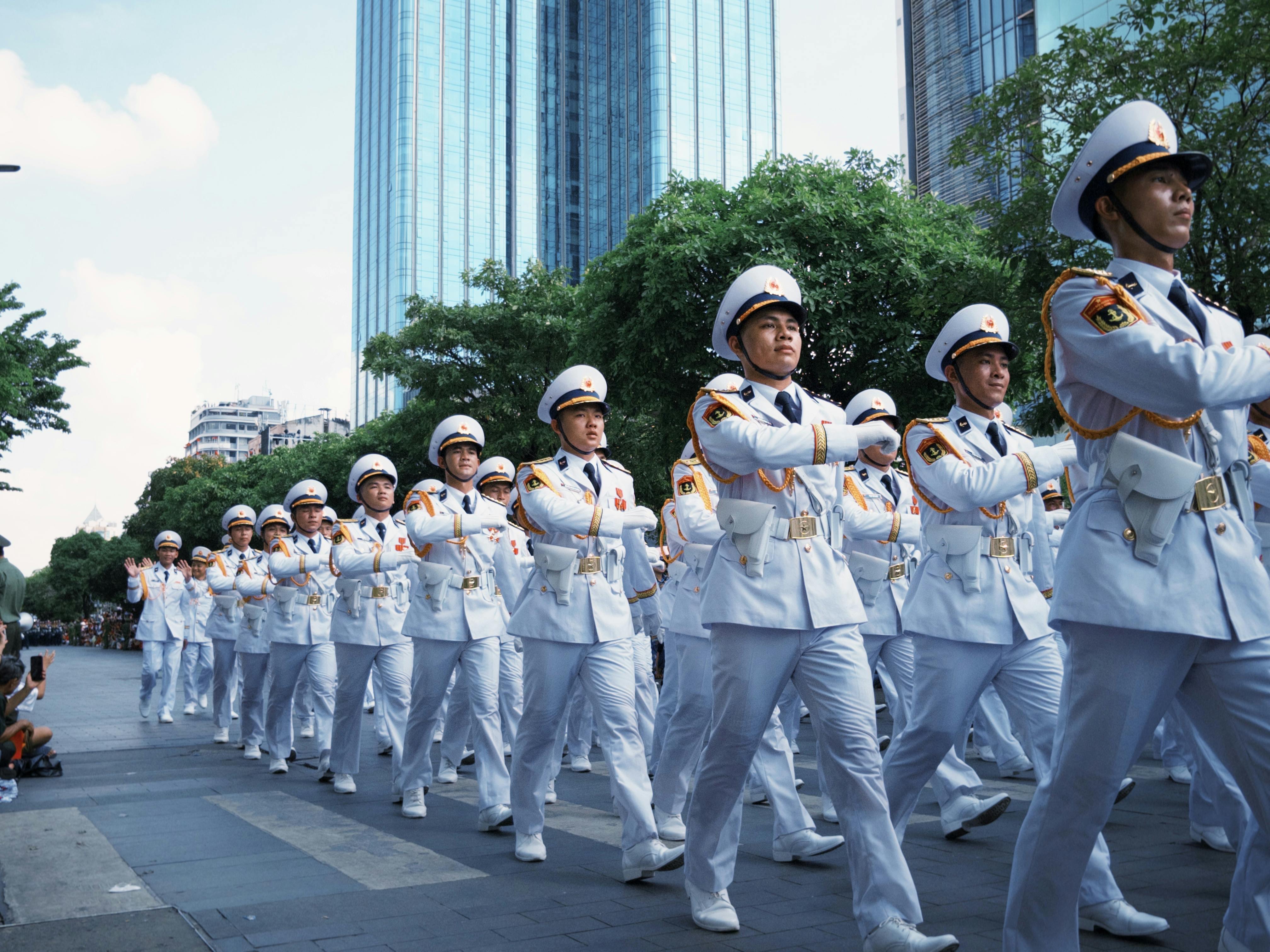 Group of uniformed officers marching in a city parade.