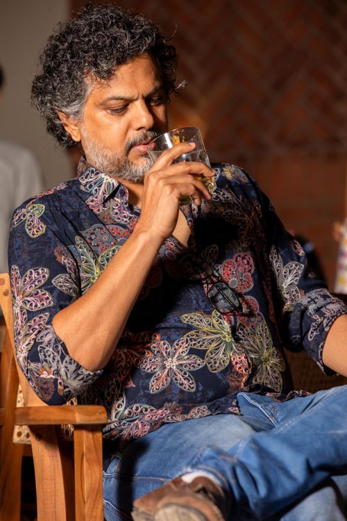 Free Casual adult man savoring a drink in a relaxed atmosphere, indoors. Stock Photo