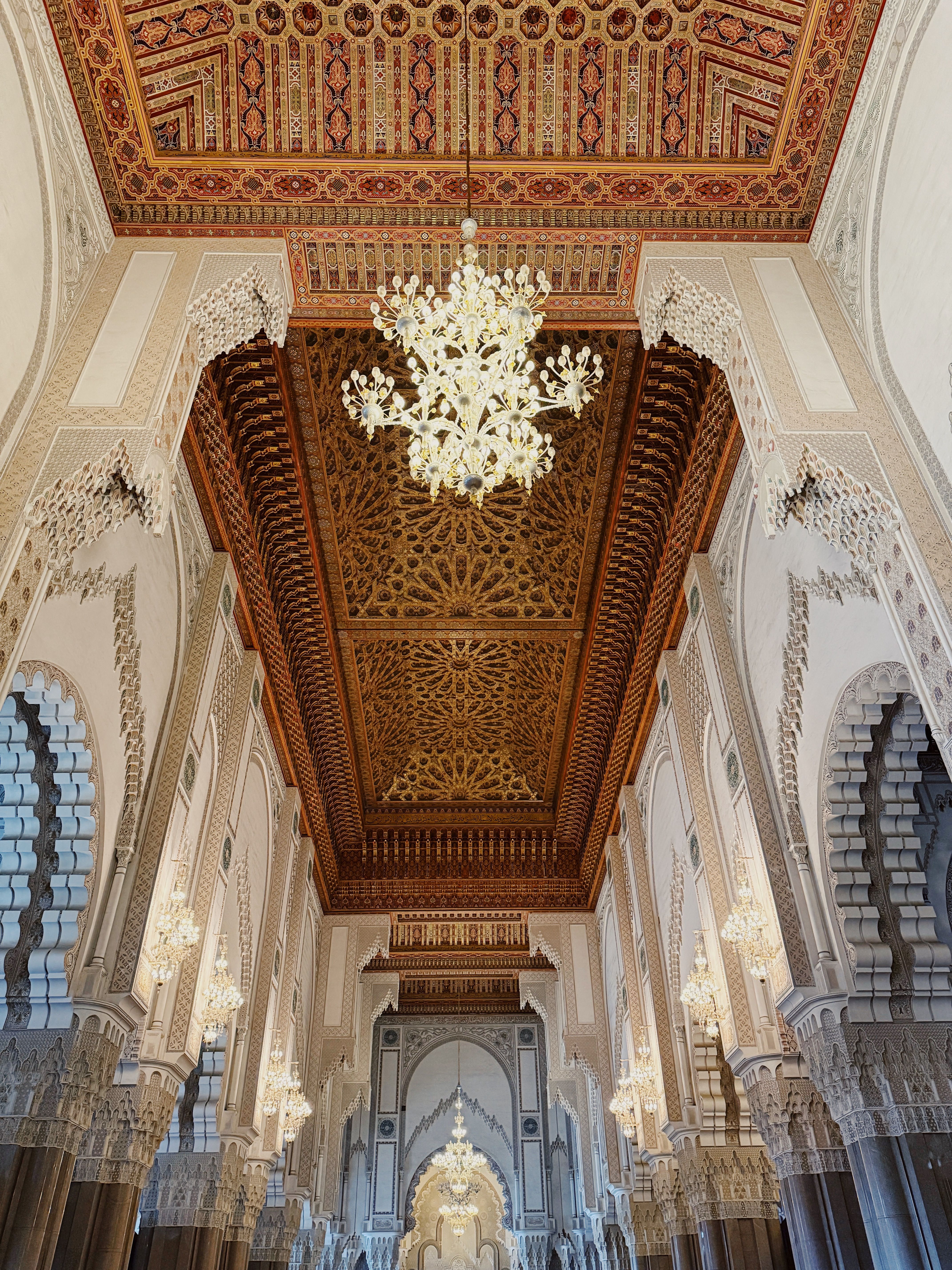 Ornate Islamic-style ceiling with chandeliers — dining atmosphere