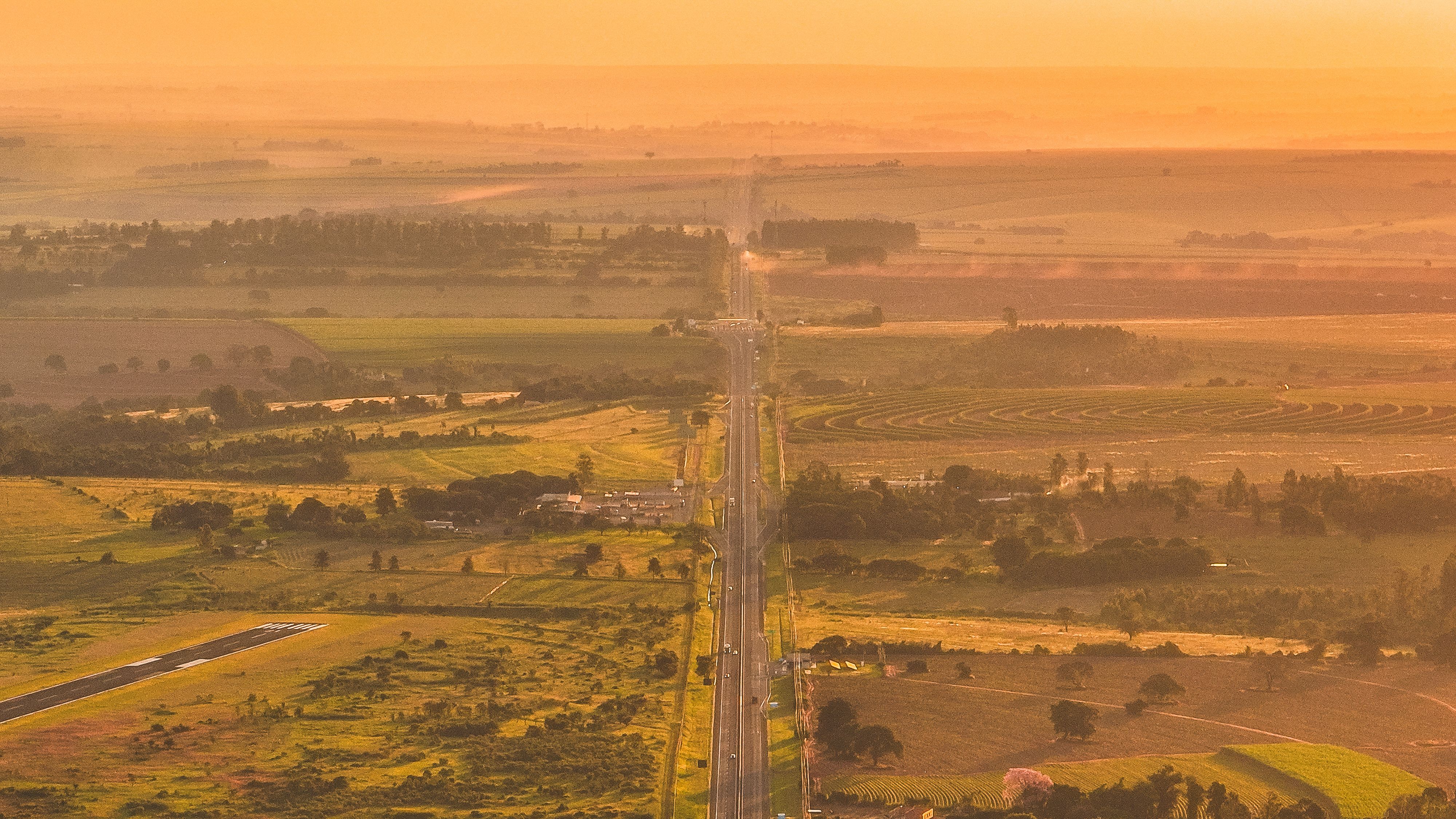 Scenic Aerial View of Rural Road at Sunset · Free Stock Photo