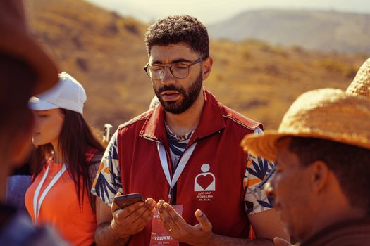 Volunteers gathered outdoors for a community meeting, promoting teamwork and collaboration.