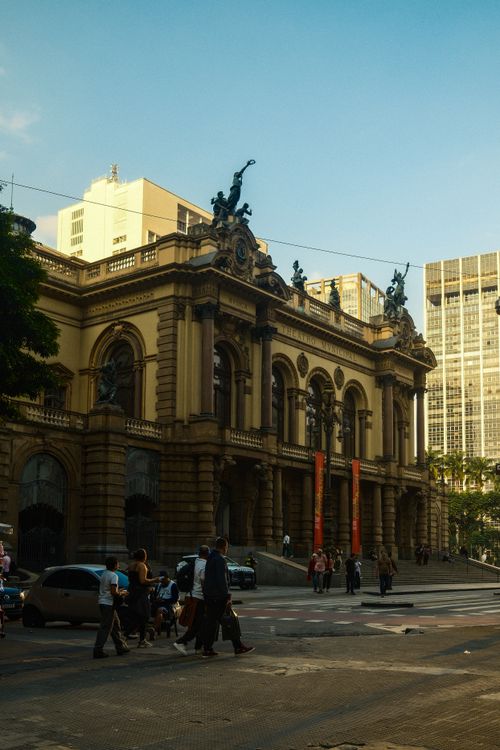 Free Exterior view of the iconic São Paulo Municipal Theater with pedestrians in the foreground. Stock Photo