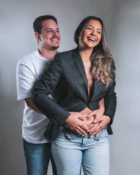 Joyful couple sharing an embrace, showcasing love and togetherness in casual clothing.