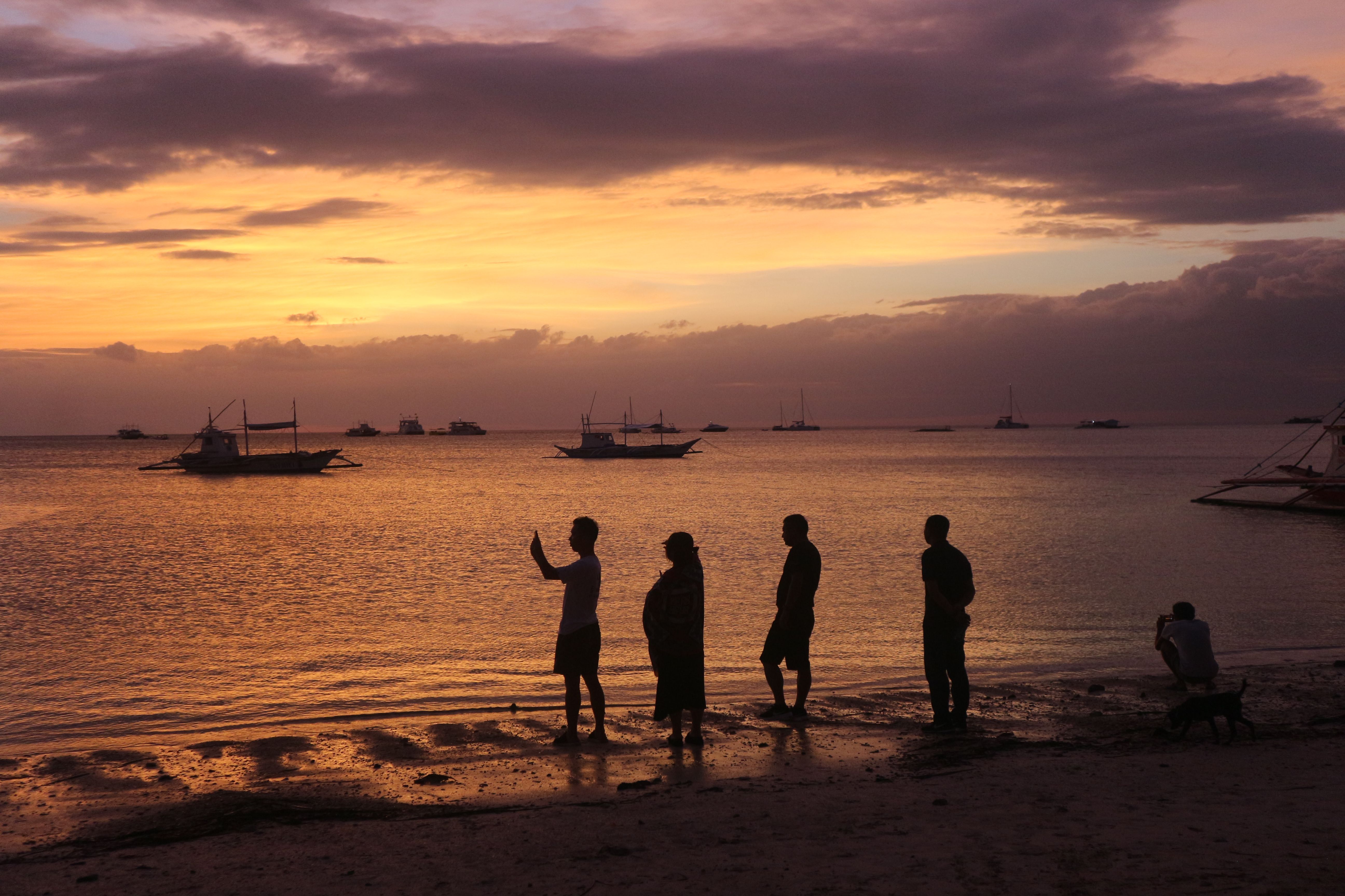 Silhouette of People at Beach During Sunset · Free Stock Photo